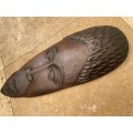 African wood face carving dark wood  , as if a  mask wall mount
