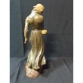 A WOOD CARVING OF WOMAN HOLDING A BABY