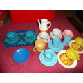 Tinplate and plastic cups and saucers and plates.