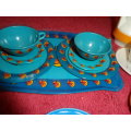 Tinplate and plastic cups and saucers and plates.