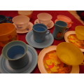 Tinplate and plastic cups and saucers and plates.