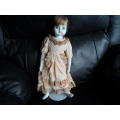 Vintage Porcelain doll.  Has a chip on foot needs some TLC
