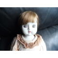 Vintage Porcelain doll.  Has a chip on foot needs some TLC