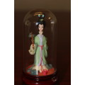 Vintage Hand Sculpted Miniature Japanese Geisha in green dress on wooden base with glass dome 8.6cm
