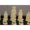 ANTIQUE CHINESE HANDCARVED and STAINED BONE CHESS SET WITH LACQUERED WOODEN BOARD/CASE 34 BY 35 CM