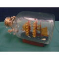SHIP IN GLASS BOTTLE CORKED AND WOODEN STAND