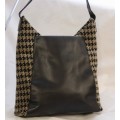 AUTHENTIC TUMI LEATHER AND WOOL BAG. COMES WITH MATERIAL DUSTCOVER