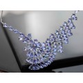DRAMATIC AND ELEGANT TANZANITE AND STERLING SILVER WAVE-LIKE RIGID FEATURE PENDANT. BOX CHAIN