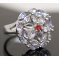 NATURAL TANZANITE FLORAL OPEN WORK PATTERN STERLING SILVER RING WITH CHERRY RED SAPPHIRE ACCENT. 925