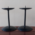 Two small vintage black painted steel candle holders