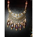 Lovely multi coloured beaded double necklace with brass centrepiece: DN1