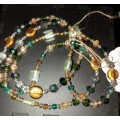 Beautiful long beaded necklace in greens and golds. LN4