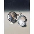 LOVELY ROUND BURNISHED SILVER EARRINGS FROM MIGLIO.