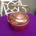 A Vintage Copper Kettle with a Brass Handle.