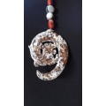 Vintage Oriental necklace. Mottled brown oriental stone pendant with what looks like a dragon spiral