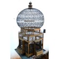 A very ornate and decorative wooden and metal bird cage, canary, finch, budgie