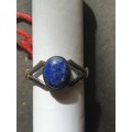 A siver ring with blue stones ovel cut stone