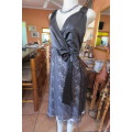 Smart black dress by `Donna Claire` in size 42/18. Cross over bust with ties.Satin top.