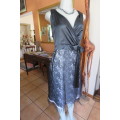 Smart black dress by `Donna Claire` in size 42/18. Cross over bust with ties.Satin top.