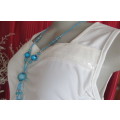 Femininei white top with square sequined neckline. Sleeveless size 36/12.In polyester/nylon.As new