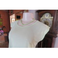 Sheer polyester/nylon applegreen sleeveless top with round neckline size 36/12. As new