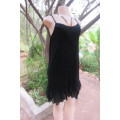 Ultra sexy black strappy dress in stretch viscose size 34/10. Loose hanging. Lace frills.As new