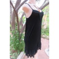 Ultra sexy black strappy dress in stretch viscose size 34/10. Loose hanging. Lace frills.As new
