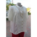 Top of the line rich cream short sleeve top by 'Donatella' size 42/18. As new
