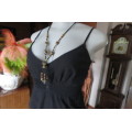Cute black strappy top with wide elasticated waist by `RT` in size 32/8. Tiestring around hips.