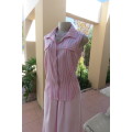 Cute pink and cream vertical striped sleeveless top in size 32/8 by INSYNC. Two dummy pockets.