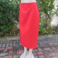Smart red ankle length pencil style skirt in 100% wash and wear polyester. Slitted sides. Size 44/20