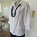 Snow white button down top with cuffed bracelet length sleeves.By MICHAELA in size 38/14