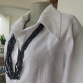 Snow white button down top with cuffed bracelet length sleeves.By MICHAELA in size 38/14