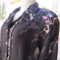 Pretty black sheer polyester long sleeve top with lilac,grey and green flowers. Size 42/18.Good cond