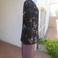 Pretty black sheer polyester long sleeve top with lilac,grey and green flowers. Size 42/18.Good cond