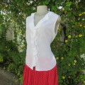 Dainty white sleeveless frilled top in sheer embroidered polyester. Size 36/12 By WOOLWORTHS.As new.