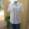 Casual white short sleeve top closing with press buttons. Size 36/12 by RT. Cowboy yokes.As new