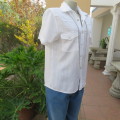 Casual white short sleeve top closing with press buttons. Size 36/12 by RT. Cowboy yokes.As new