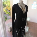 Fabulous used black sexy long sleeve top from IQ in size 38/14.Low plunging neckline.Front buckle