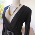Fabulous used black sexy long sleeve top from IQ in size 38/14.Low plunging neckline.Front buckle