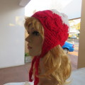 Warm earflap hat with ties for those cold days. New condition with pom pom.