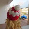 Warm earflap hat with ties for those cold days. New condition with pom pom.