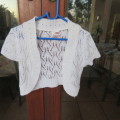 Cute little white knitted short sleeve bolero in lace stitch for 5 to 6 years old girl. As new.
