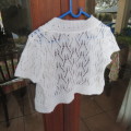 Cute little white knitted short sleeve bolero in lace stitch for 5 to 6 years old girl. As new.