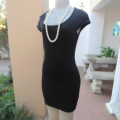Little black dress with capped sleeves and scooped neckline. Size 32/8 by FASHION EXPRESS. As new.