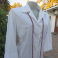 Empire style white top with elbow length sleeves and button down front with open collar. Size 40/16