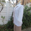 Empire style white top with elbow length sleeves and button down front with open collar. Size 40/16