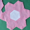 Pink and white 3 piece doily set made up in small hexagonal pieces. Sizs 1x33x18 cm and 2x20x20 cm.