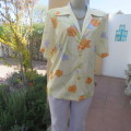 Tastefull patterned slip over top in pale yellow with orange and lilac flowers size 42/18.