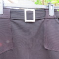 Little black ribbed polyester skirt. For girl 12 to 13 years old. Buckle on front. As new.